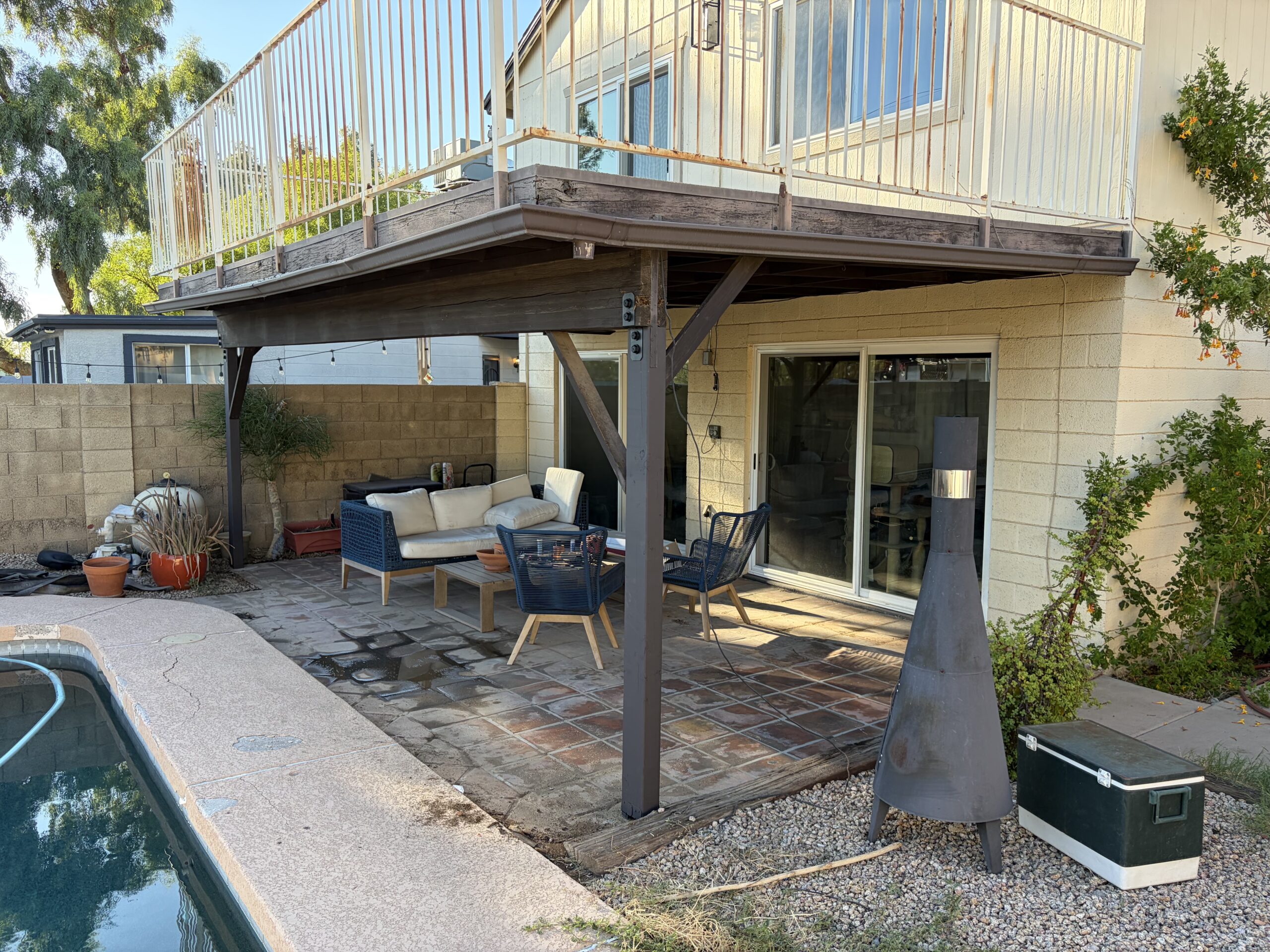 Replacement patio support post installed beneath an elevated deck